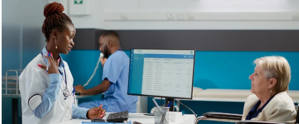 Healthcare professional assisting patient with appointment scheduling and medical records in clinic