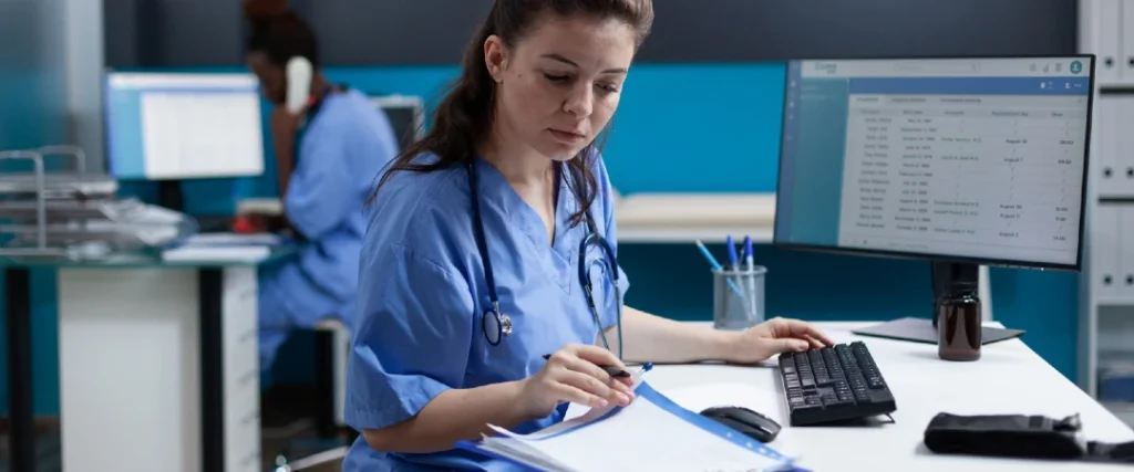 Healthcare professional managing medical billing and patient records in hospital office
