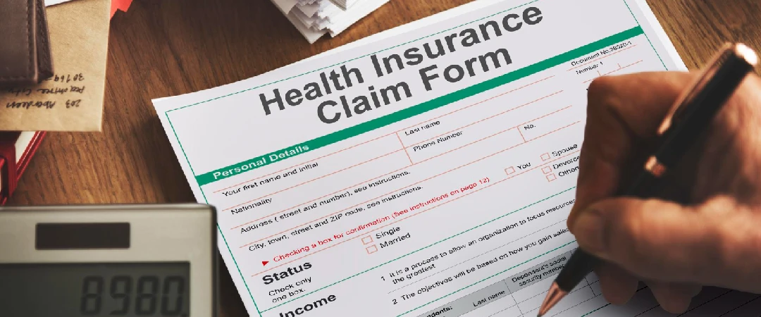Health insurance claim form being completed during patient insurance eligibility verification.