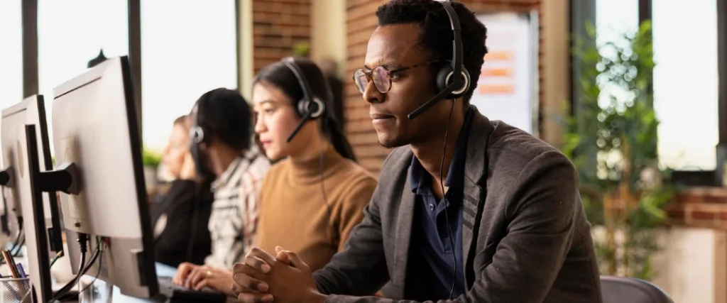 Customer service agents providing voice support in a modern call center, representing Jamaica and Philippines call center outsourcing services.