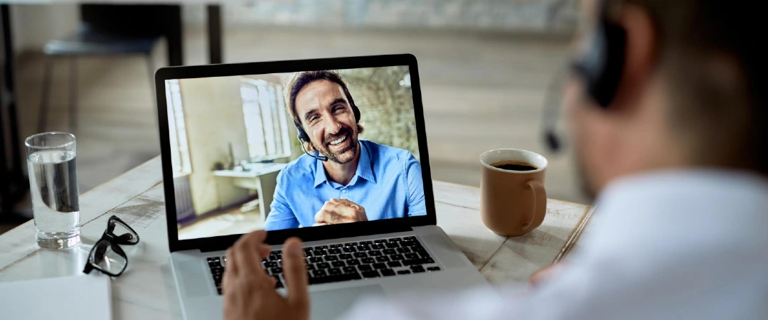 Customer speaking with a live chat support agent through a laptop video call