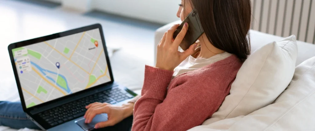 Customer tracking an ecommerce order on a laptop while speaking with customer support by phone