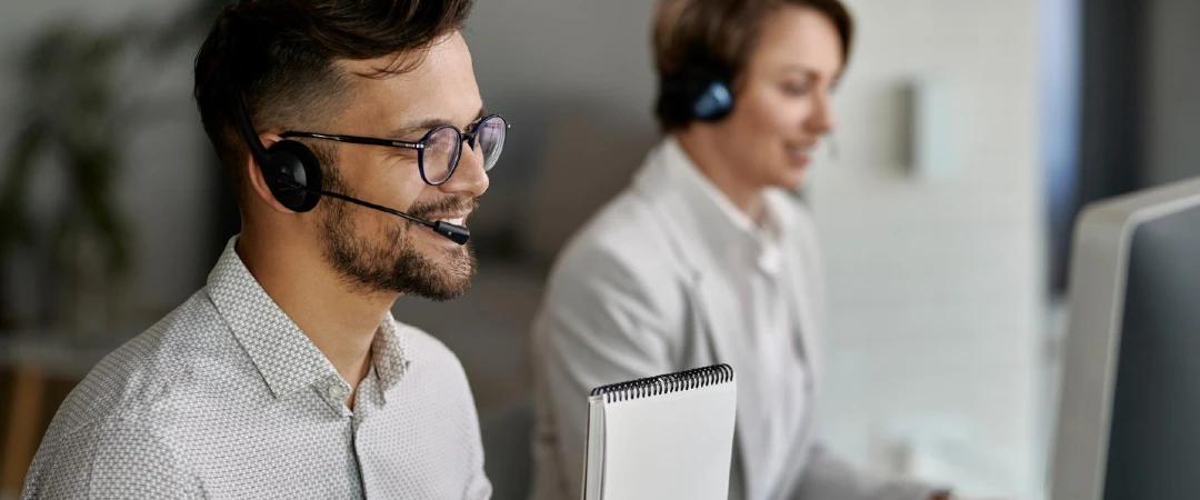 Customer support agents in Colombia assisting customers with headset-based multilingual support in a modern contact center.