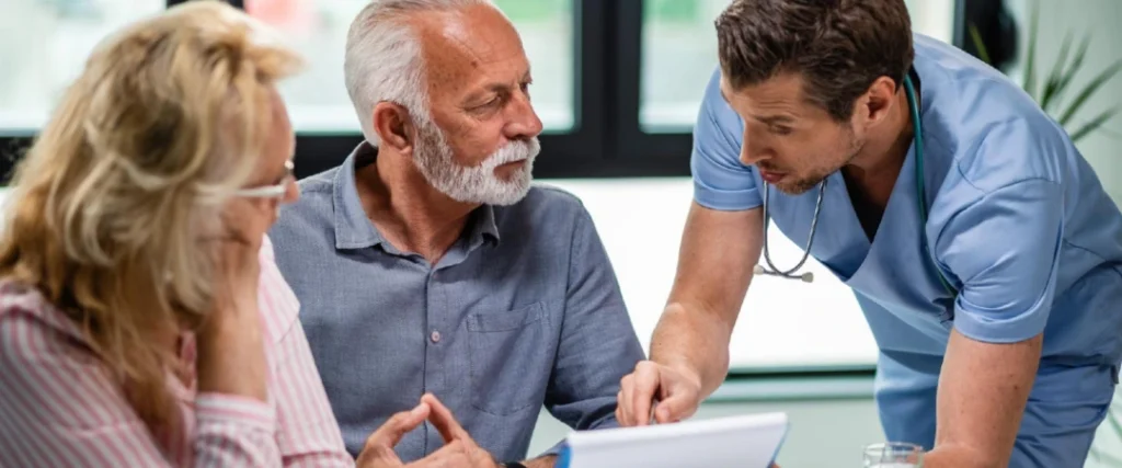 Home health nurse discussing patient care with an older couple