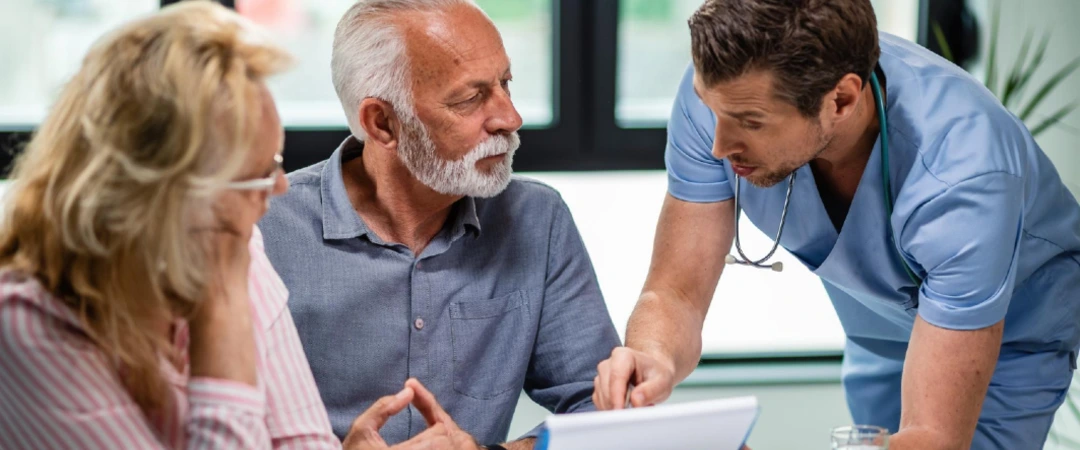 Home health nurse discussing patient care with an older couple