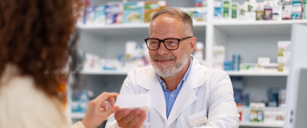 Pharmacist handing medication to a patient