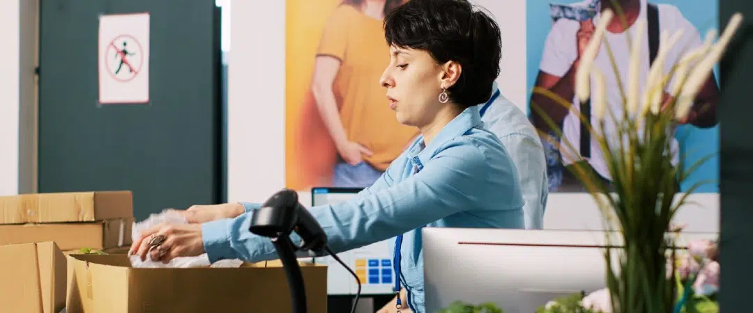 Retail worker processing online returns at a fulfillment counter