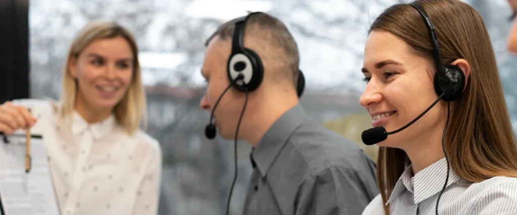 Call center agents working at computer stations with service-level performance analytics